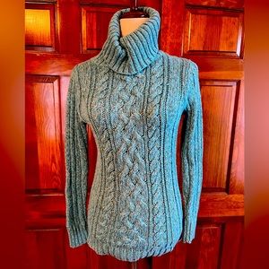 Chunky cable-knit azure blue turtleneck sweater, perfect for winter
